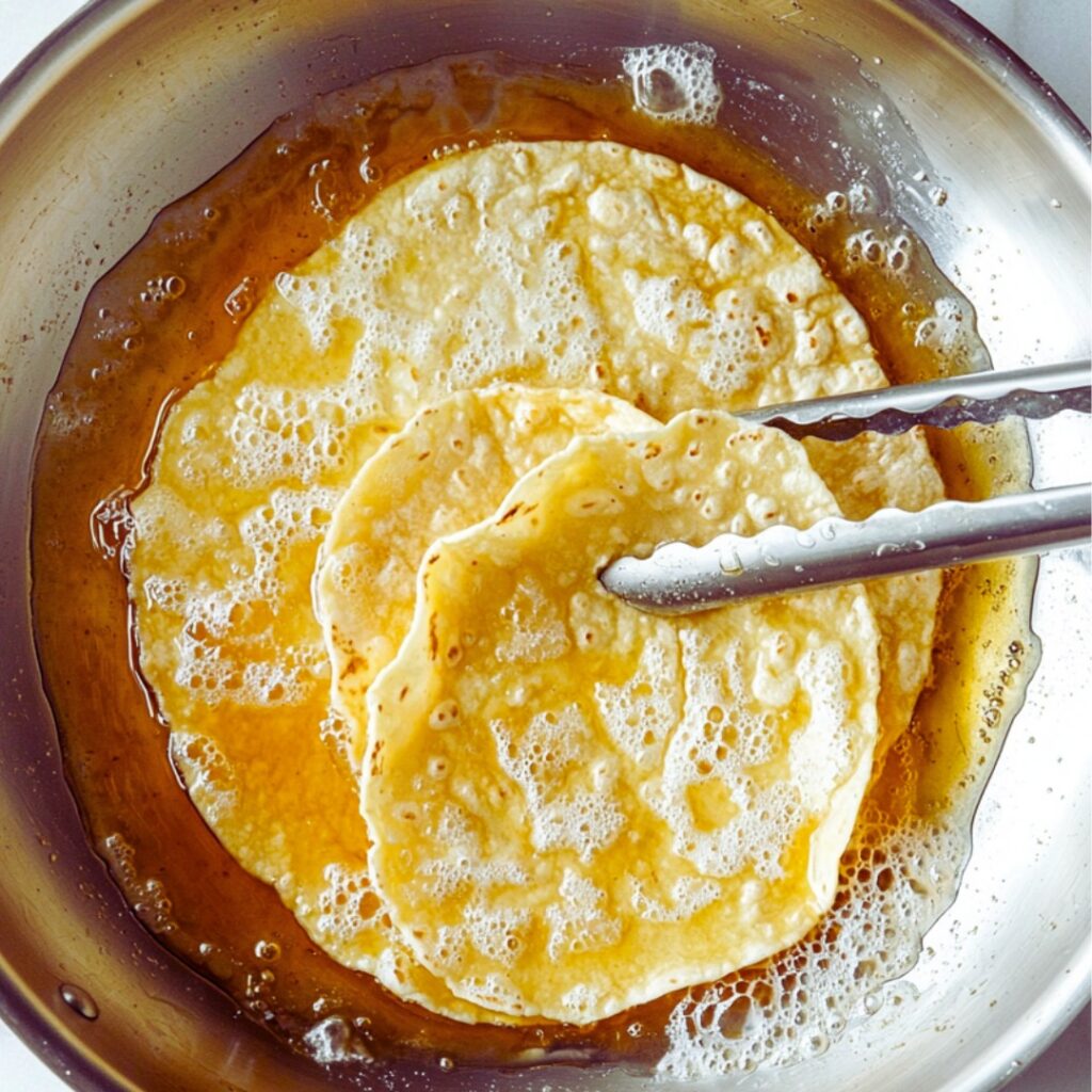 Preparing tortillas for enchiladas
